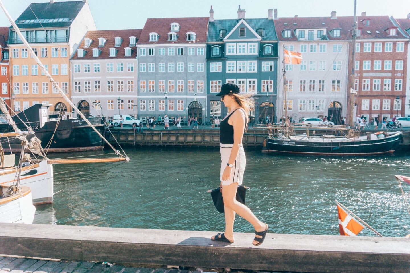 Girl with a hat walking in Nyhavn in Copenhagen