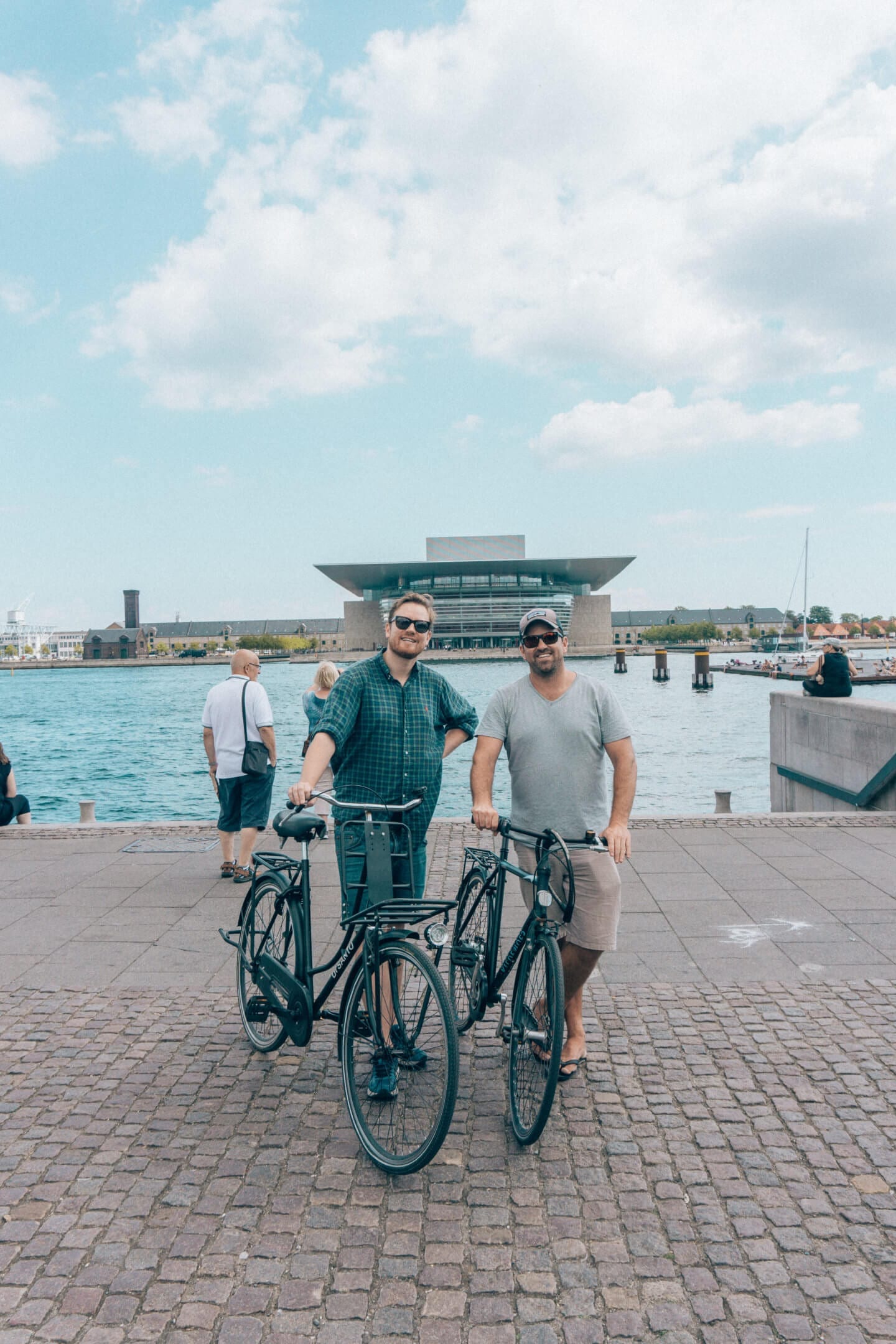 Two guys with bikes standing in from to the Copenhagen Oprah House