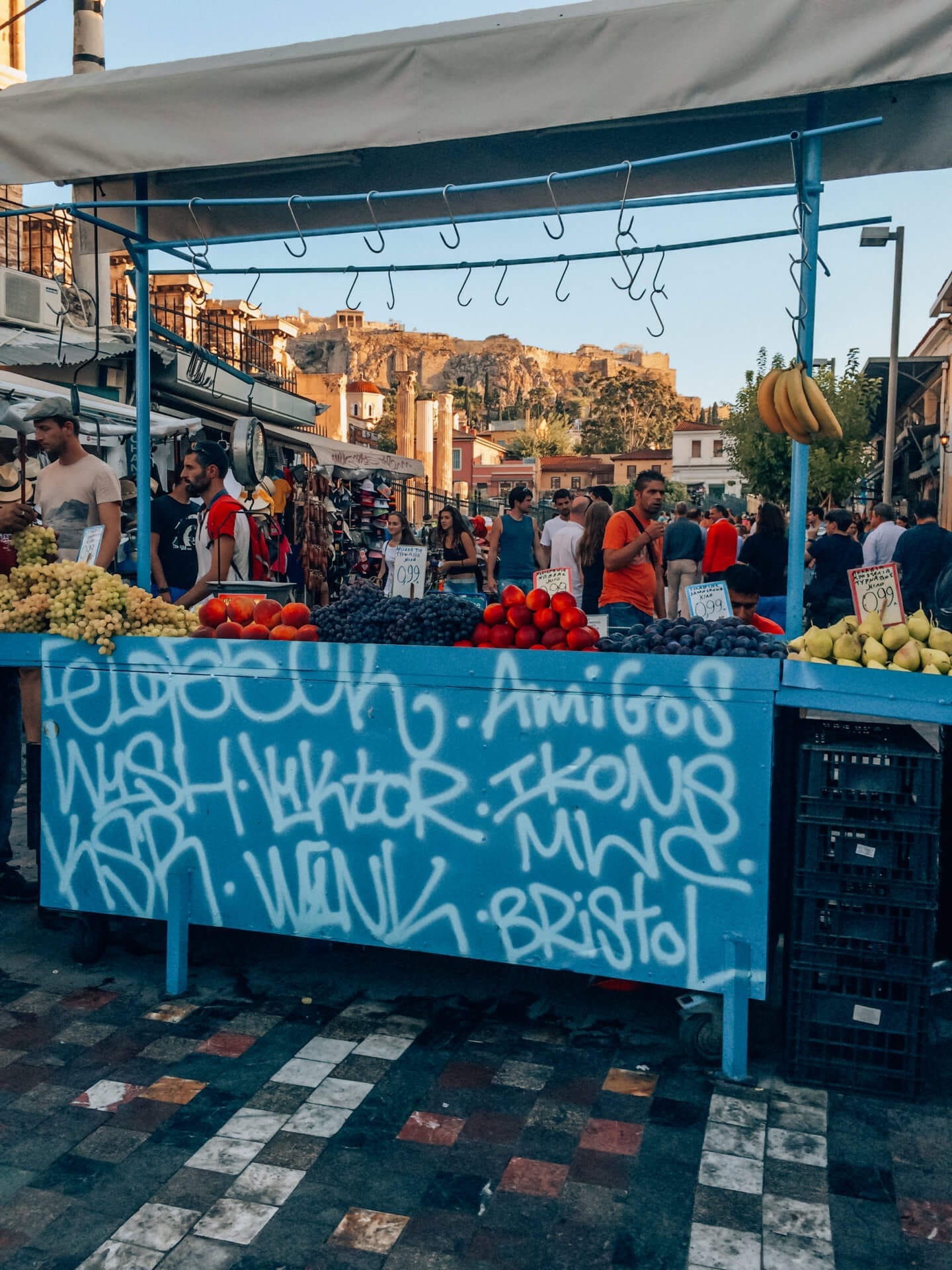 The Perfect Itinerary for 24 Hours in Athens - A blue fruit stand with Greek graffiti on it in Athens 