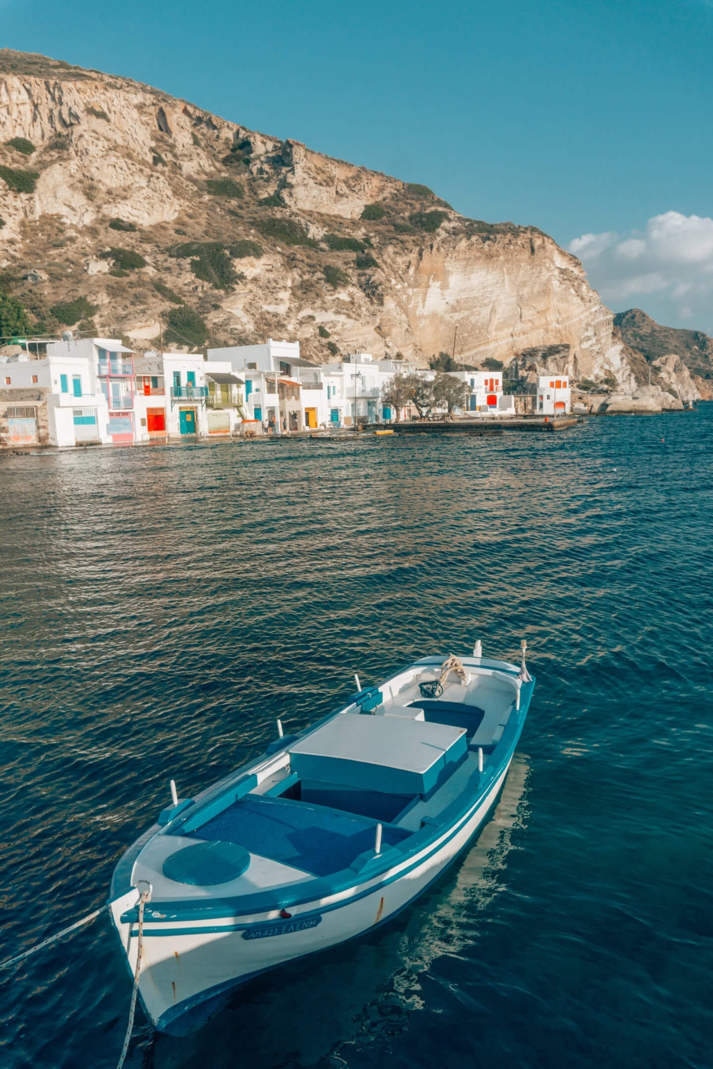 Boat floating in front of Klima - Milos