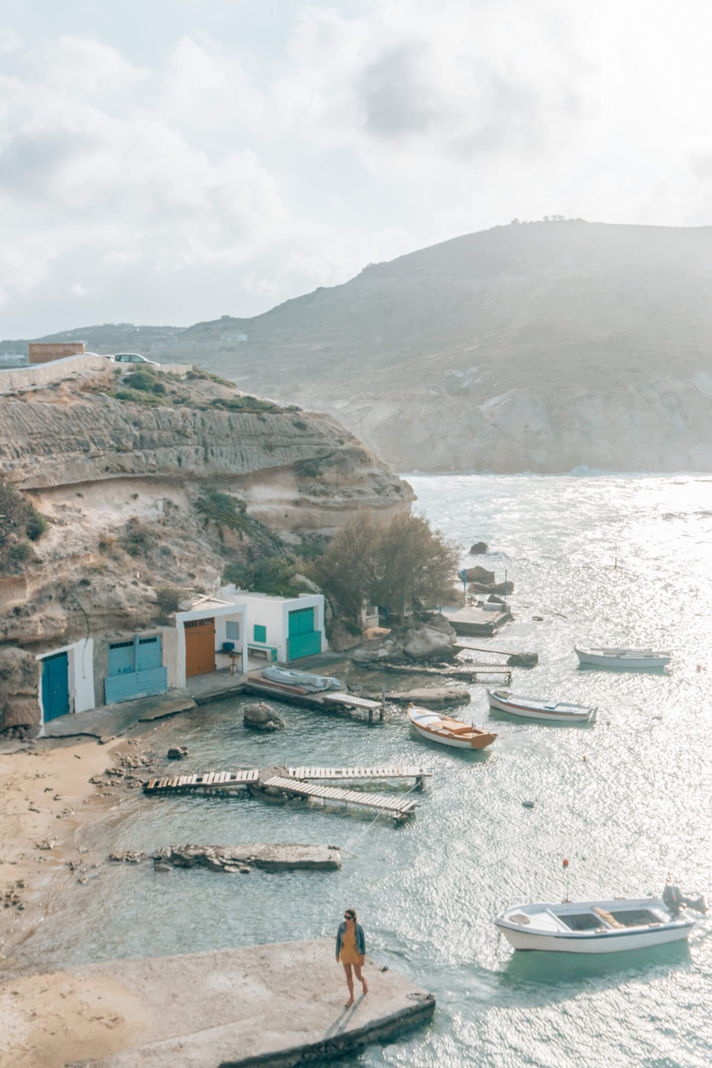 Girl standing on docks in Mandrakia fishing village - Milos travel guide