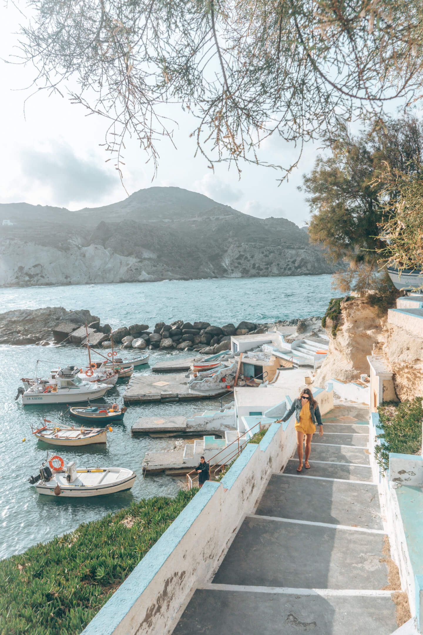 Girl walking up the steps from Mandrakia in Milos