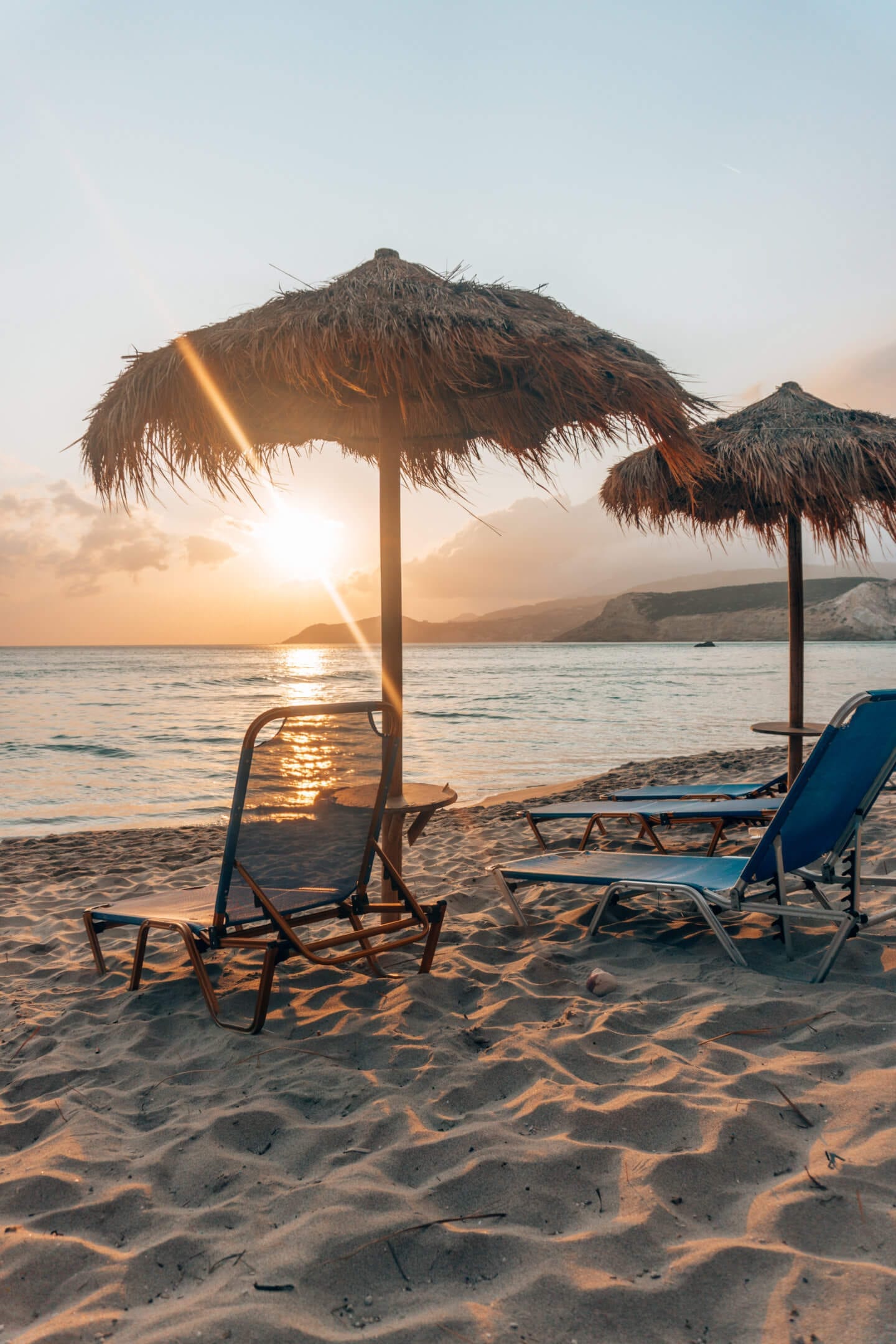 Sunsetting under beach umbrella at Firiplaka Beach - Milos travel guide
