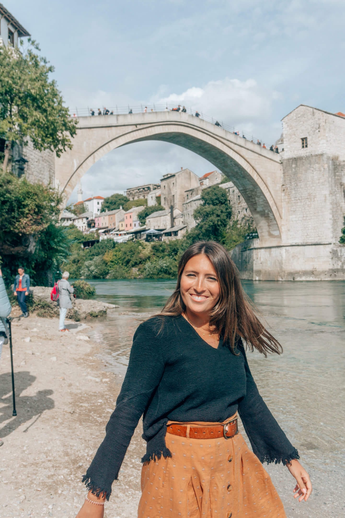 Brunette girl twirling in front of the Stari Most