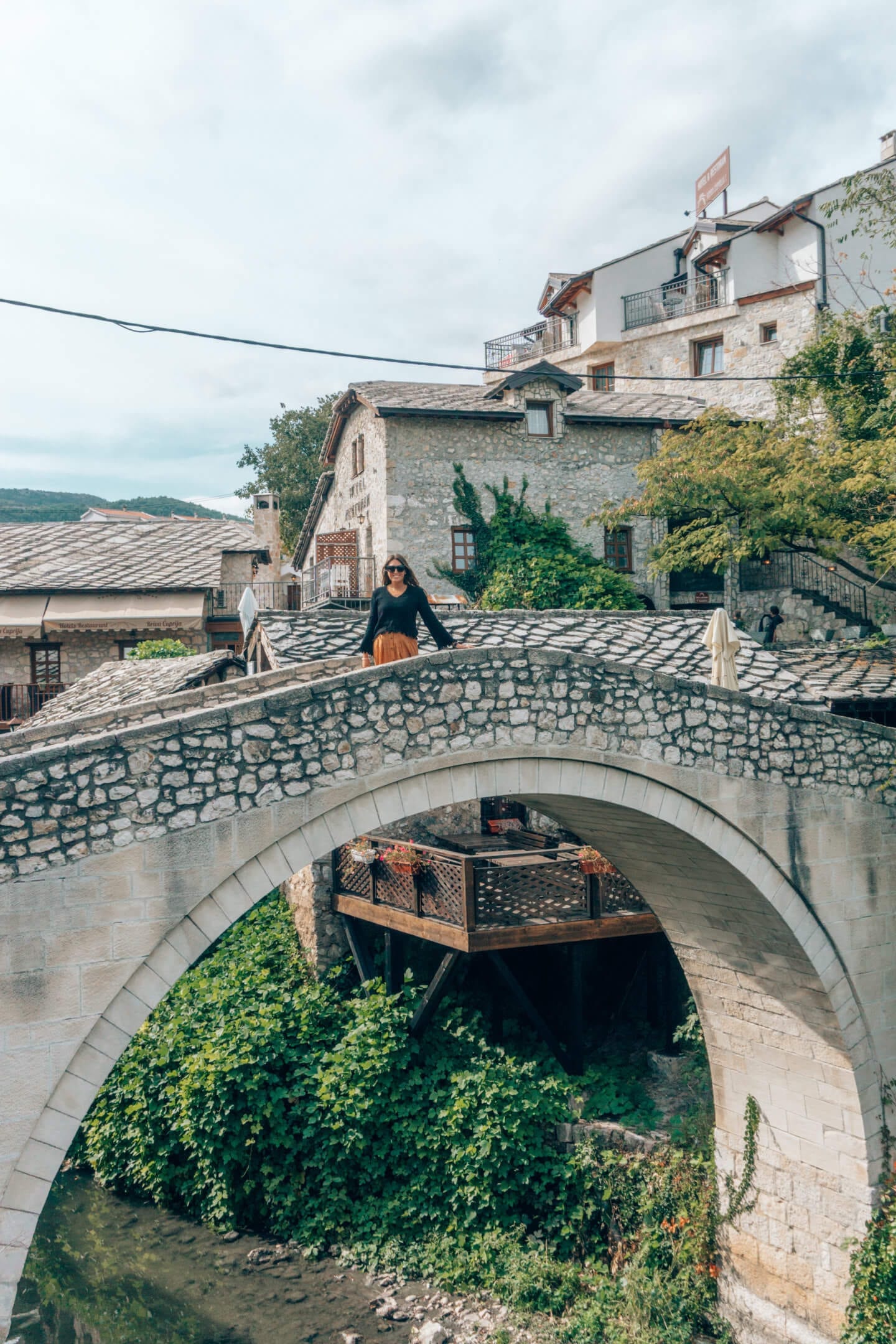 Girl standing on the Crooked Bridge in Mostar