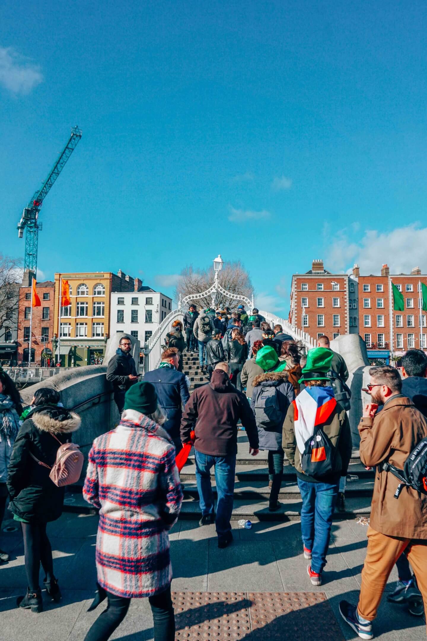 People crossing the Ha'penny Bridge in Dublin, Ireland