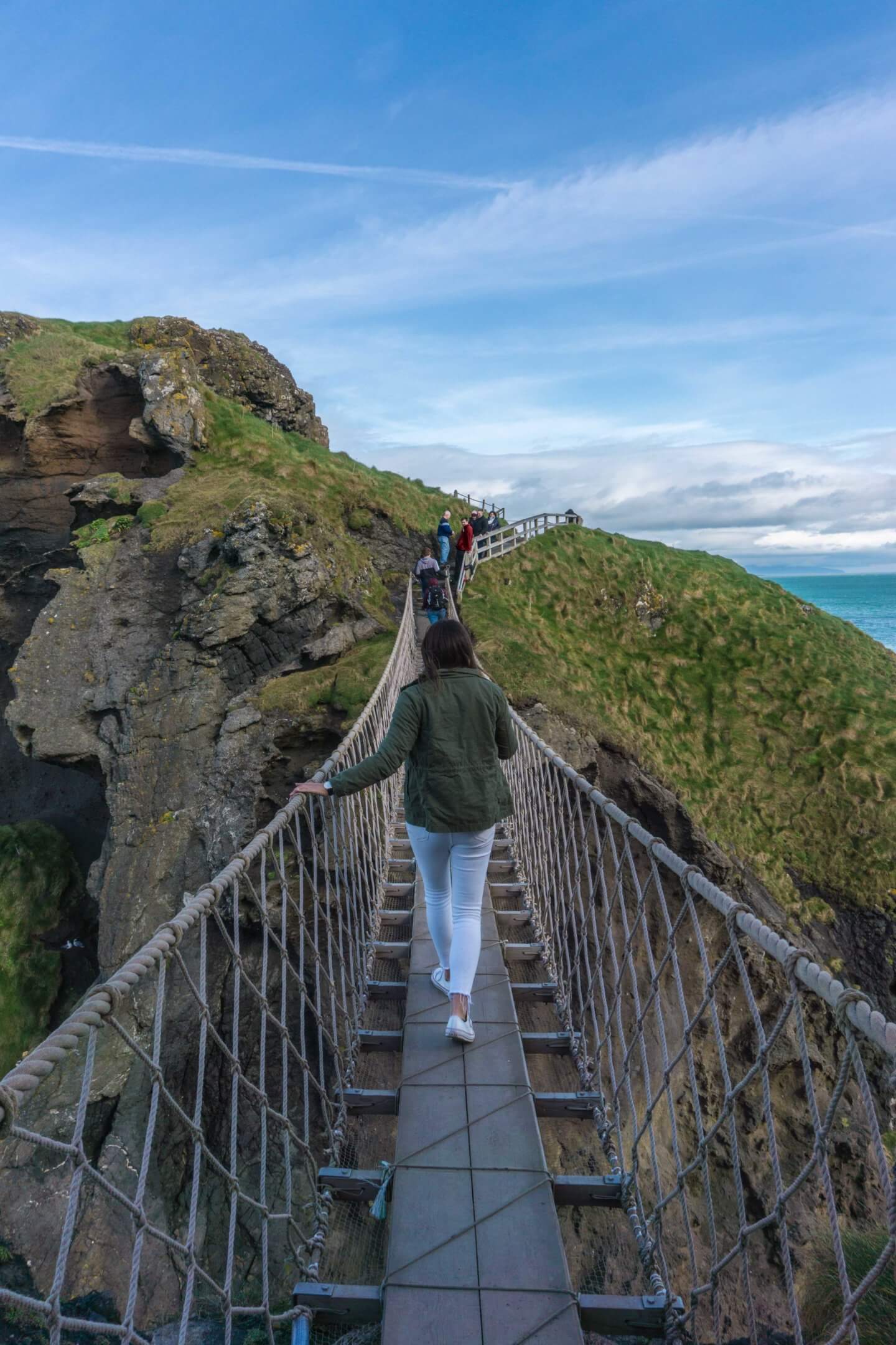 Girl crossing over the National Trust Carrick-a-Rede Rope Bridge