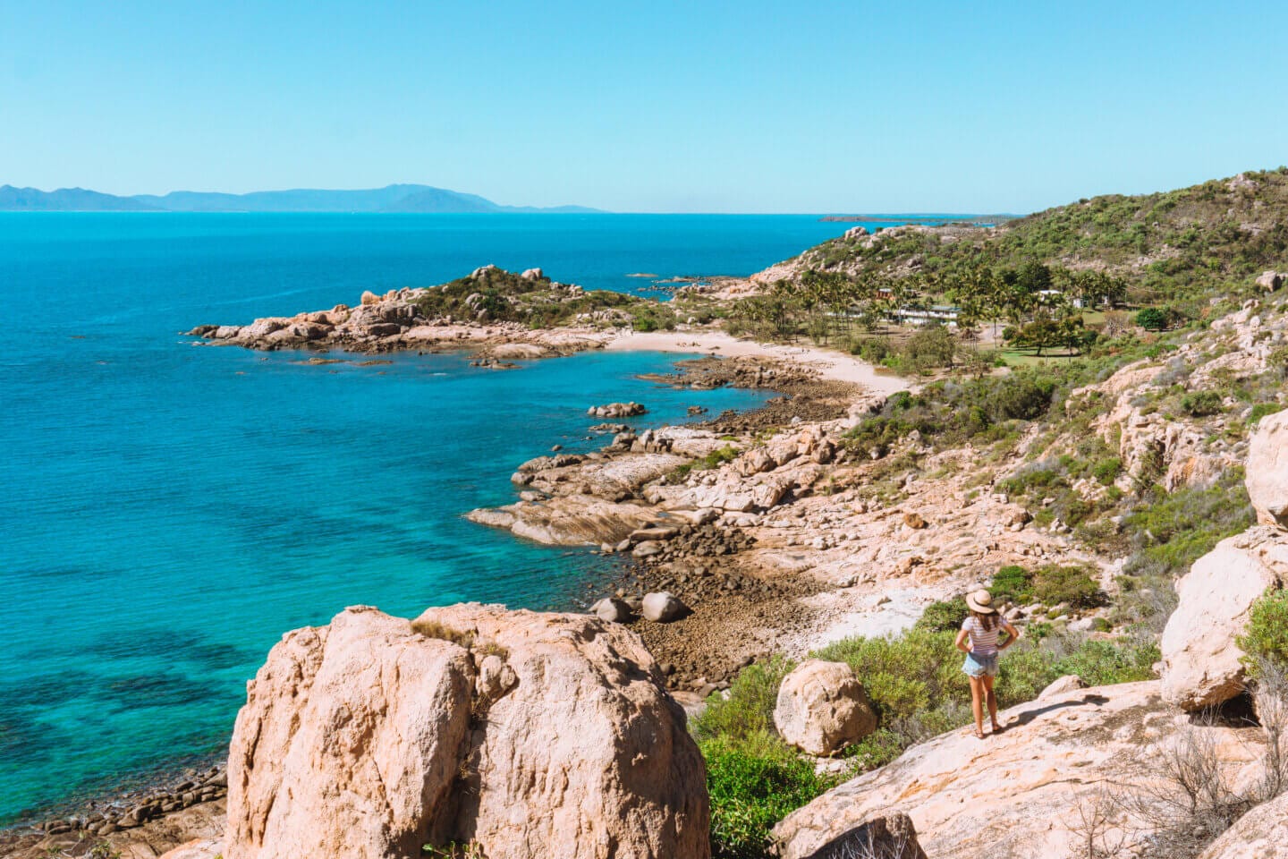 Girl with a hat on admiring the view from the Horseshoe Bay Lookout in Bowen Queensland 