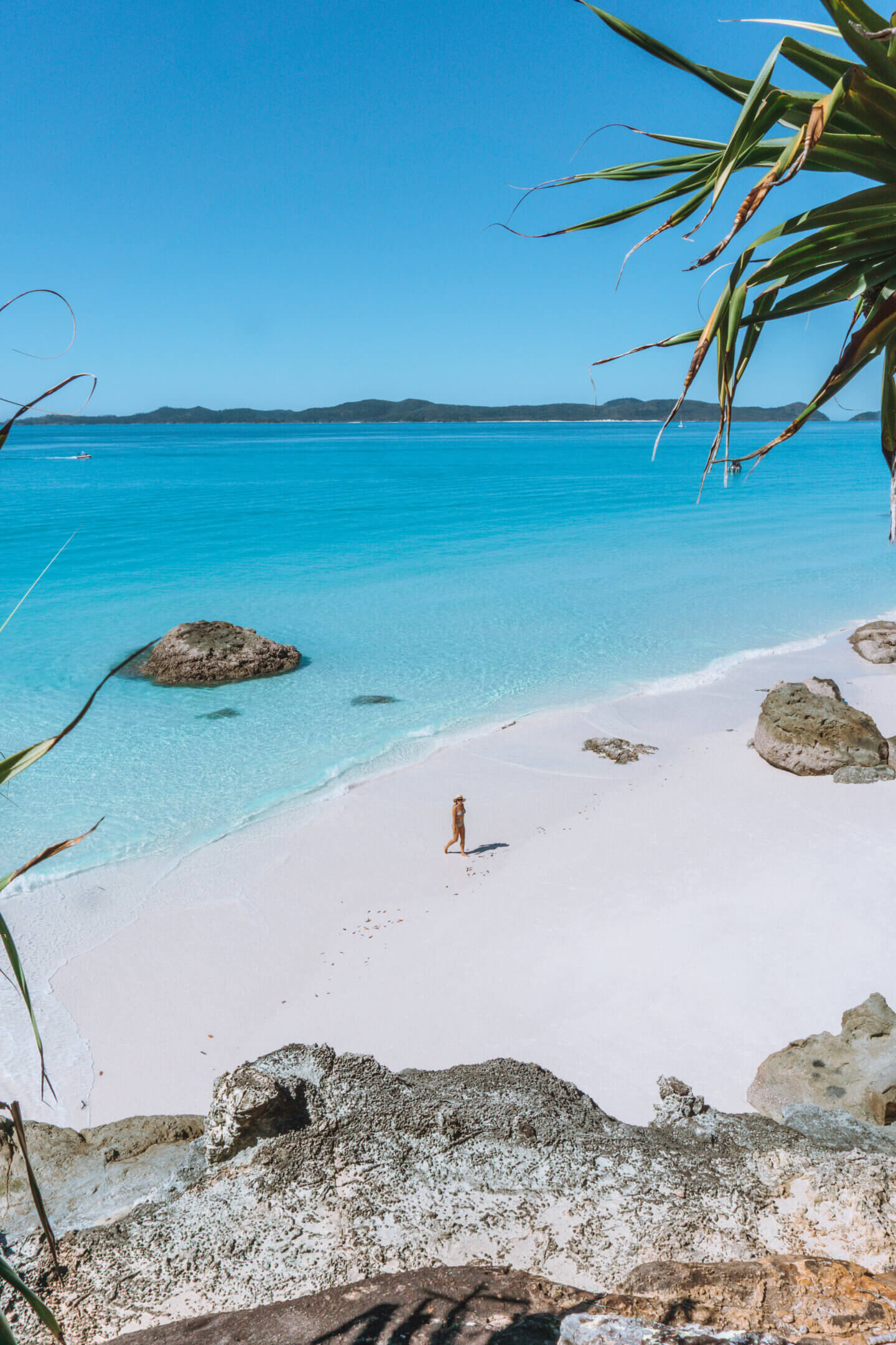 Photo looking down at a girl walking along Whitehaven Beach