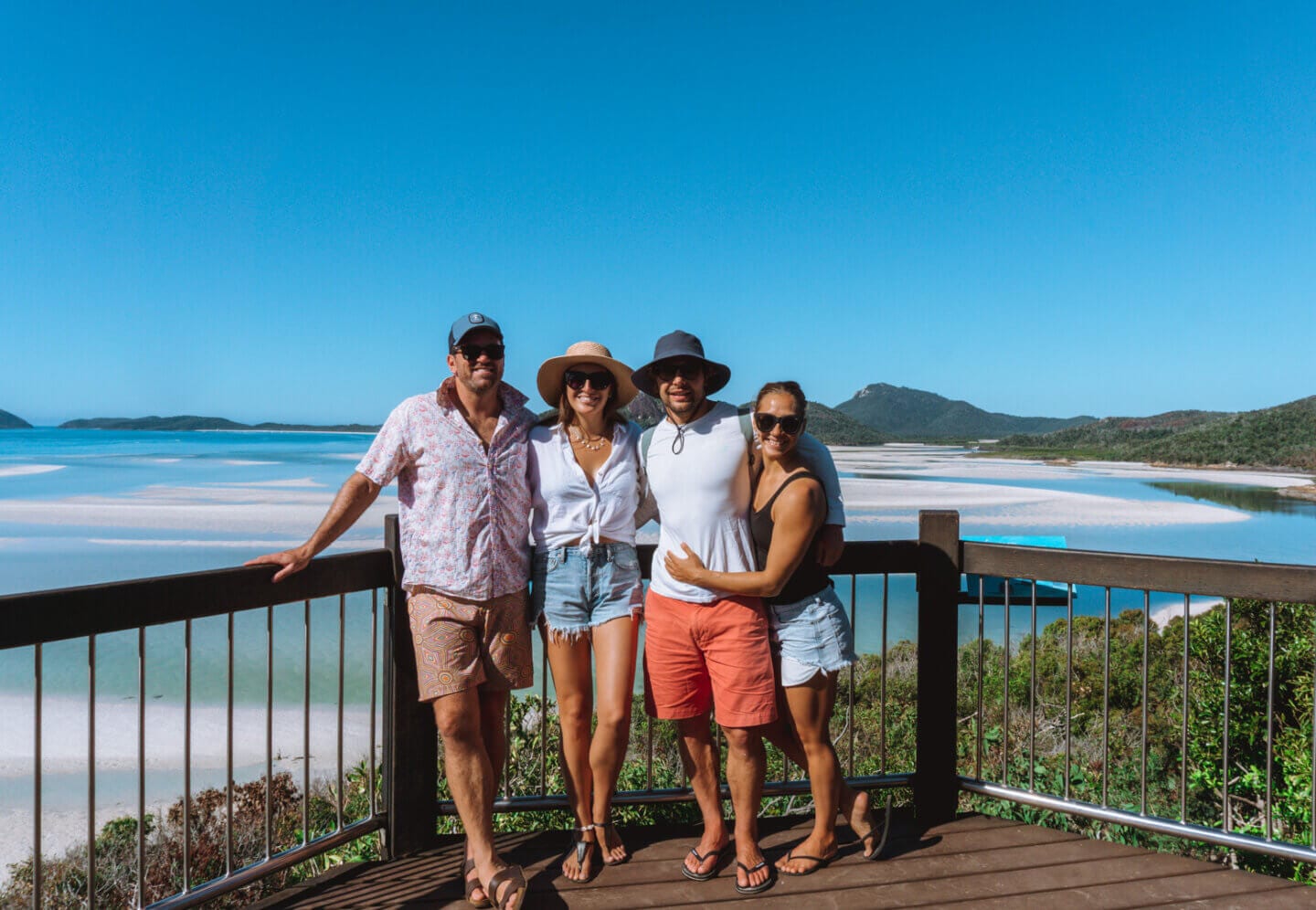 A group of friends standing at the Whitehaven beach lookout 