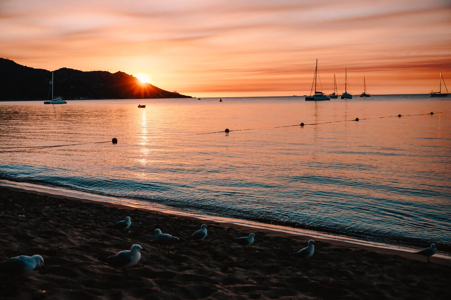 The sunsets in Horseshoe Bay on Magnetic Island with boats in the bay