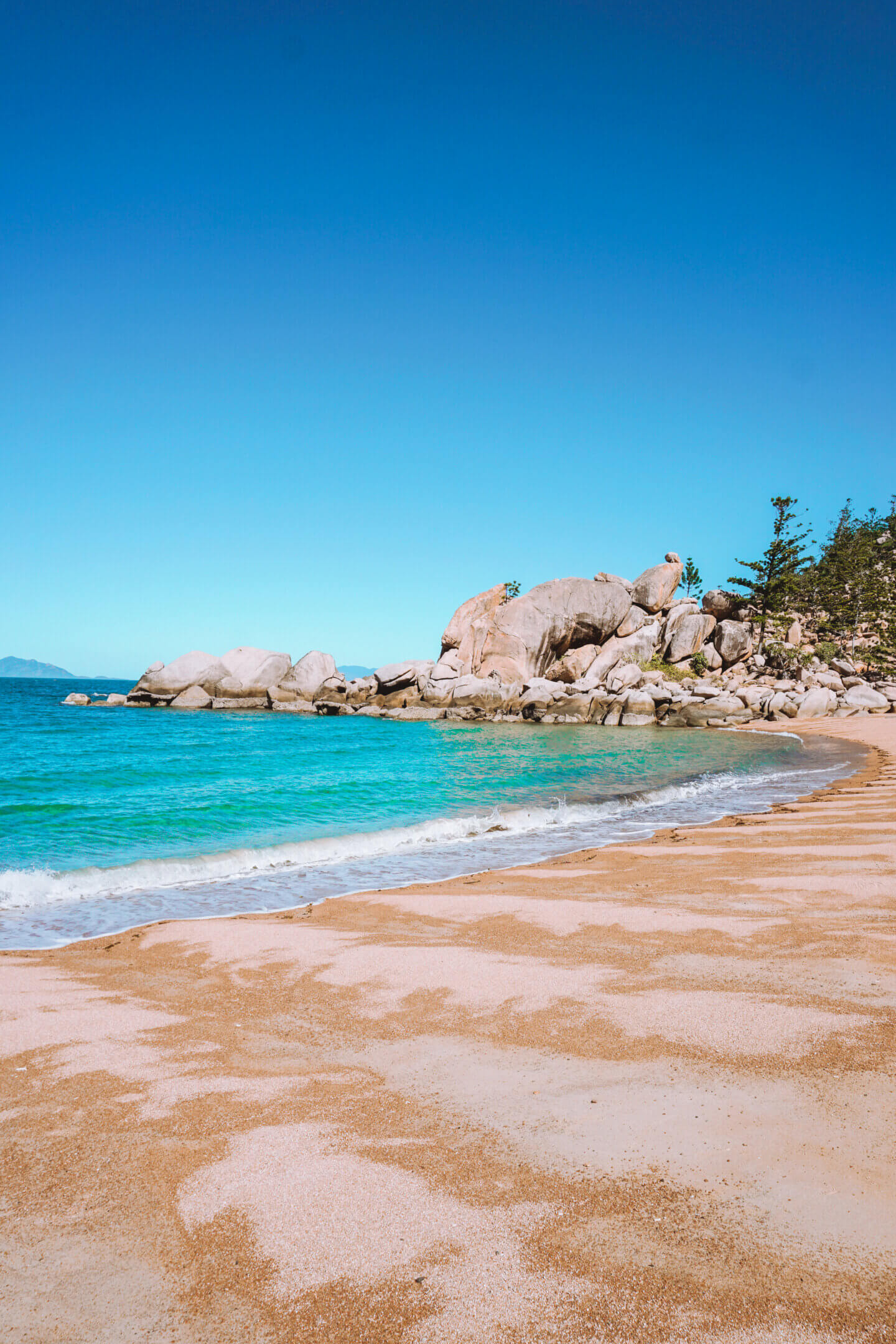 The calm blue waters and beautiful rock boulders of Arthur Bay on Magnetic Island 