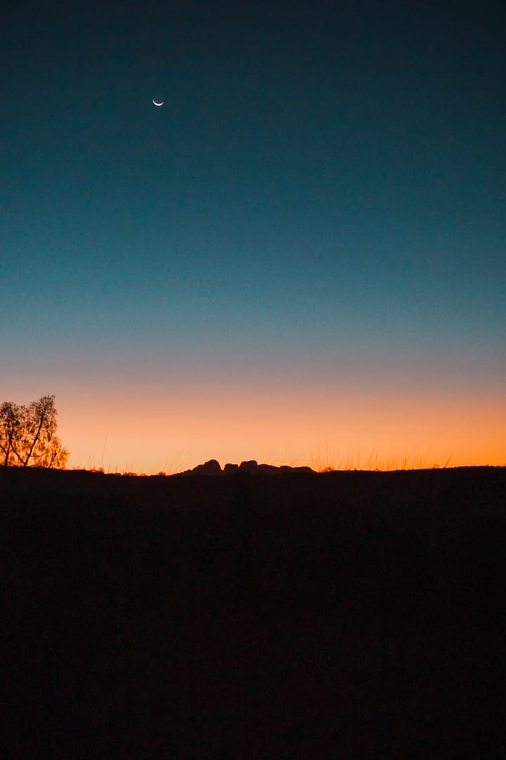 Kata Tjuta at sunset with a crescent moon