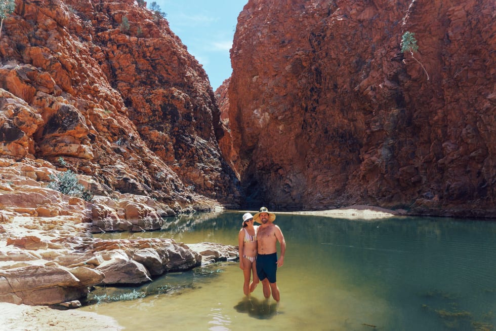 A couple standing in the middle of Redback Gorge in West Macdonnell Ranges 