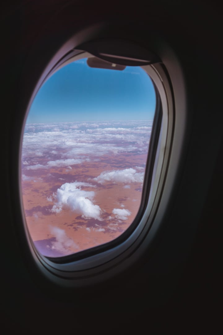 Alice Springs to Uluru: Looking out an airplane window at the Australian outback below