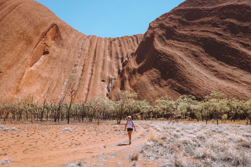 A girl doing the base walk around Uluru in Northern Territory, Austalia
