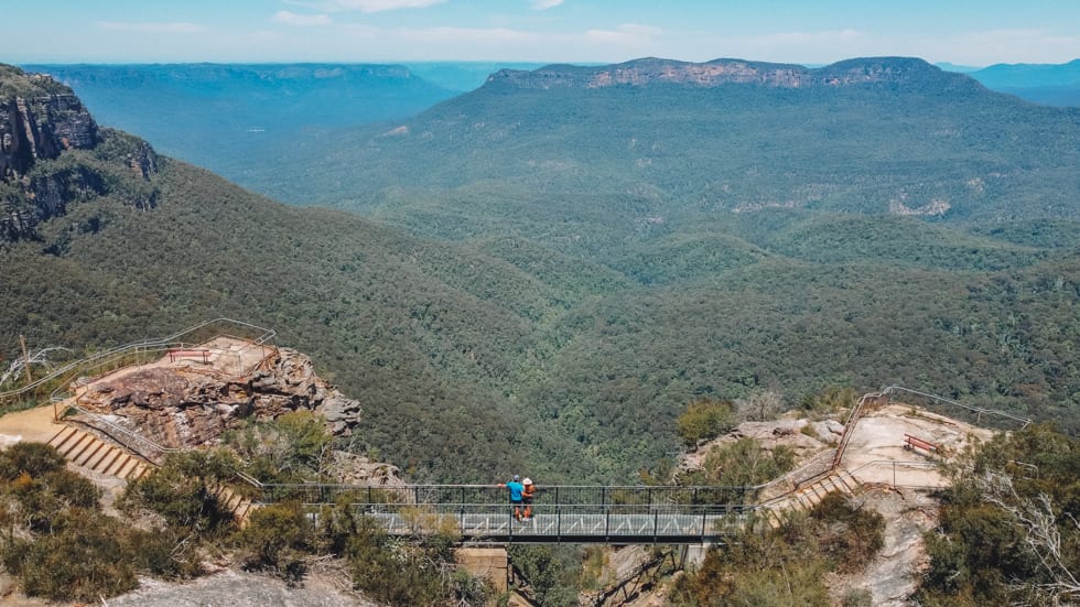 A couple enjoys the views at Elysian Rock lookout out in the Blue Mountains Australia
