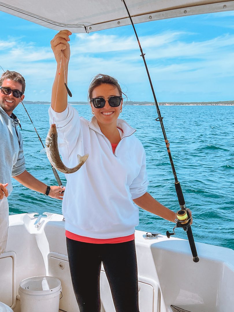 A girl fishing on a boat in Port Lincoln