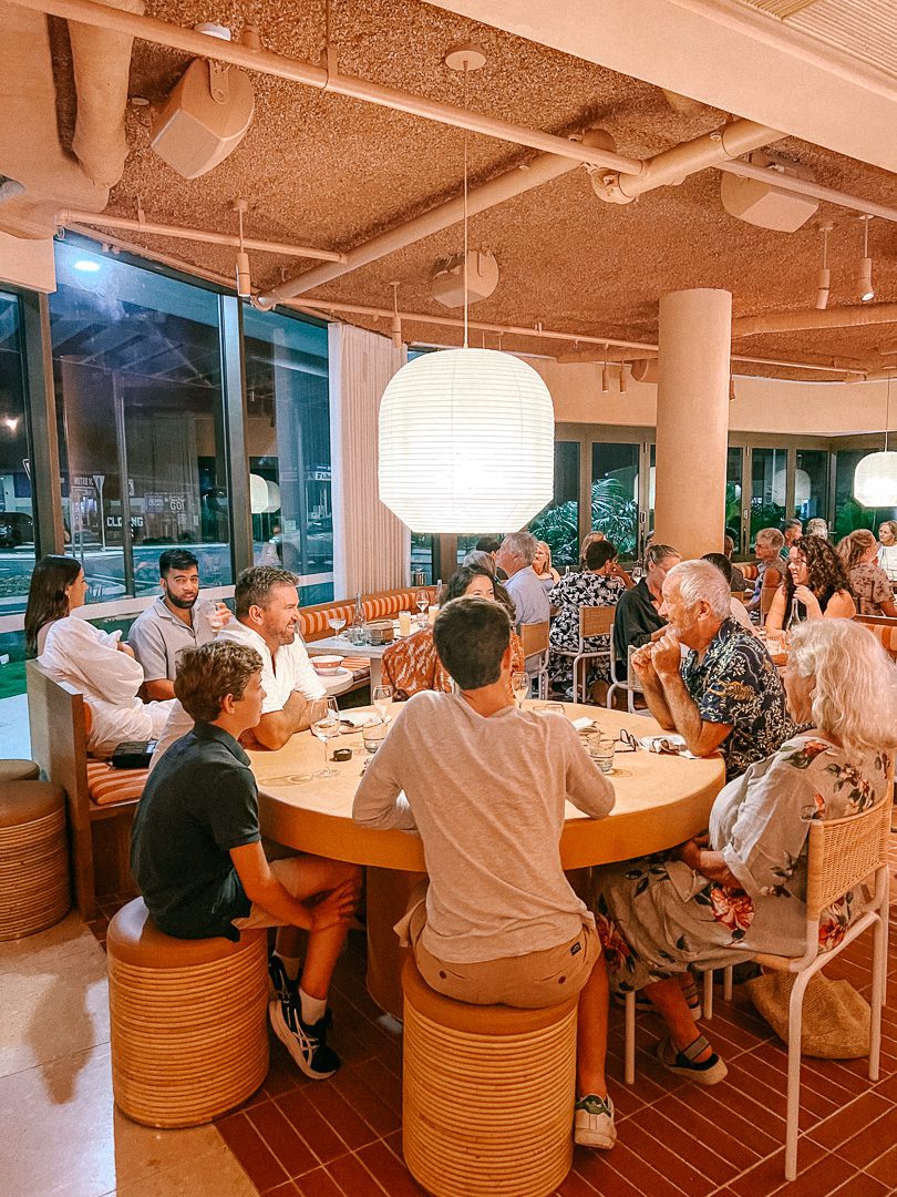 A family around a big round table at Light Years restaurant in Byron Bay