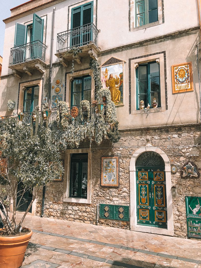 A traditional Taormina balcony, with a colourful display of plants and ceramics 