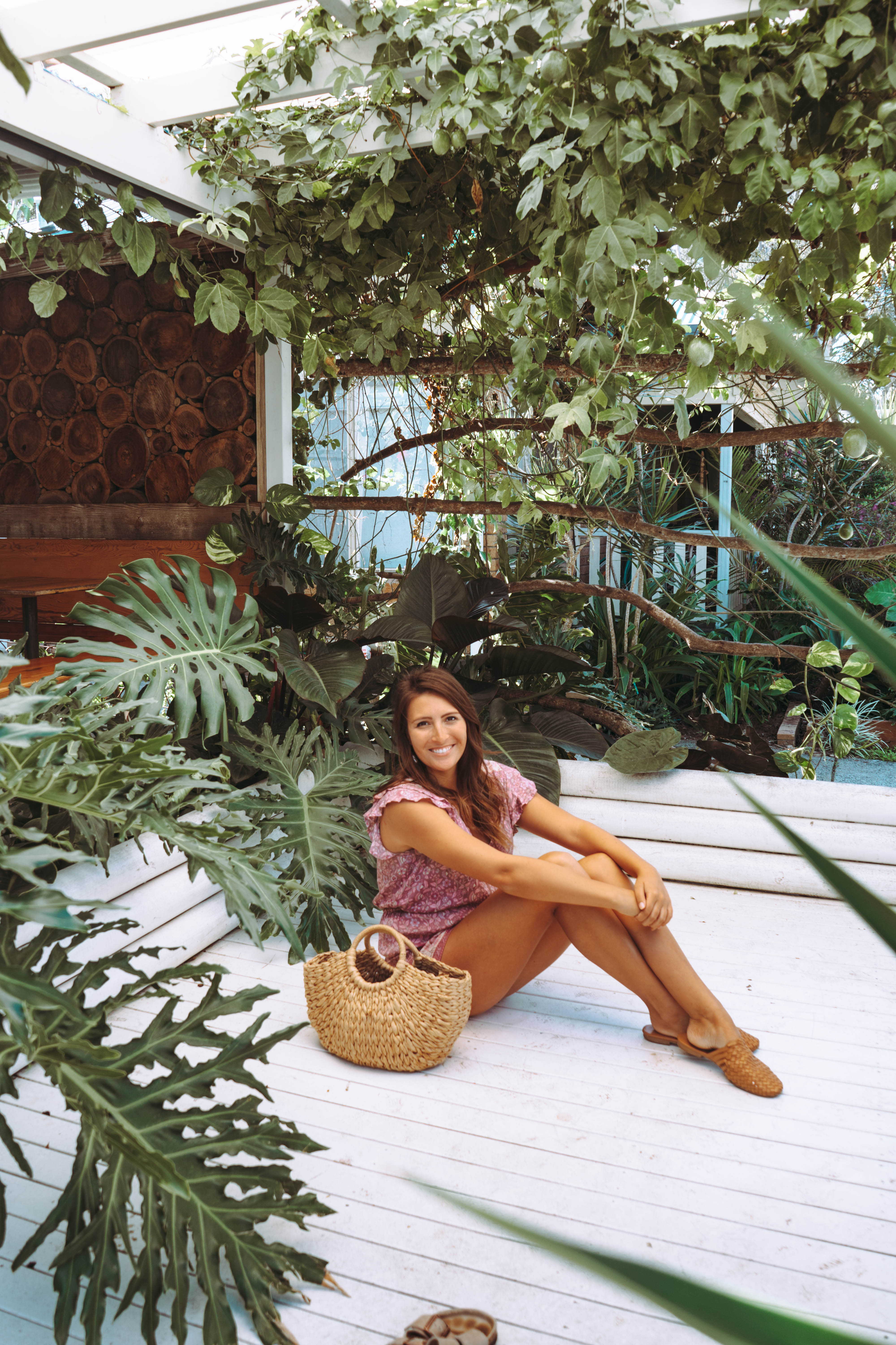 A girl sitting in the garden patio at Folk in Byron Bay 