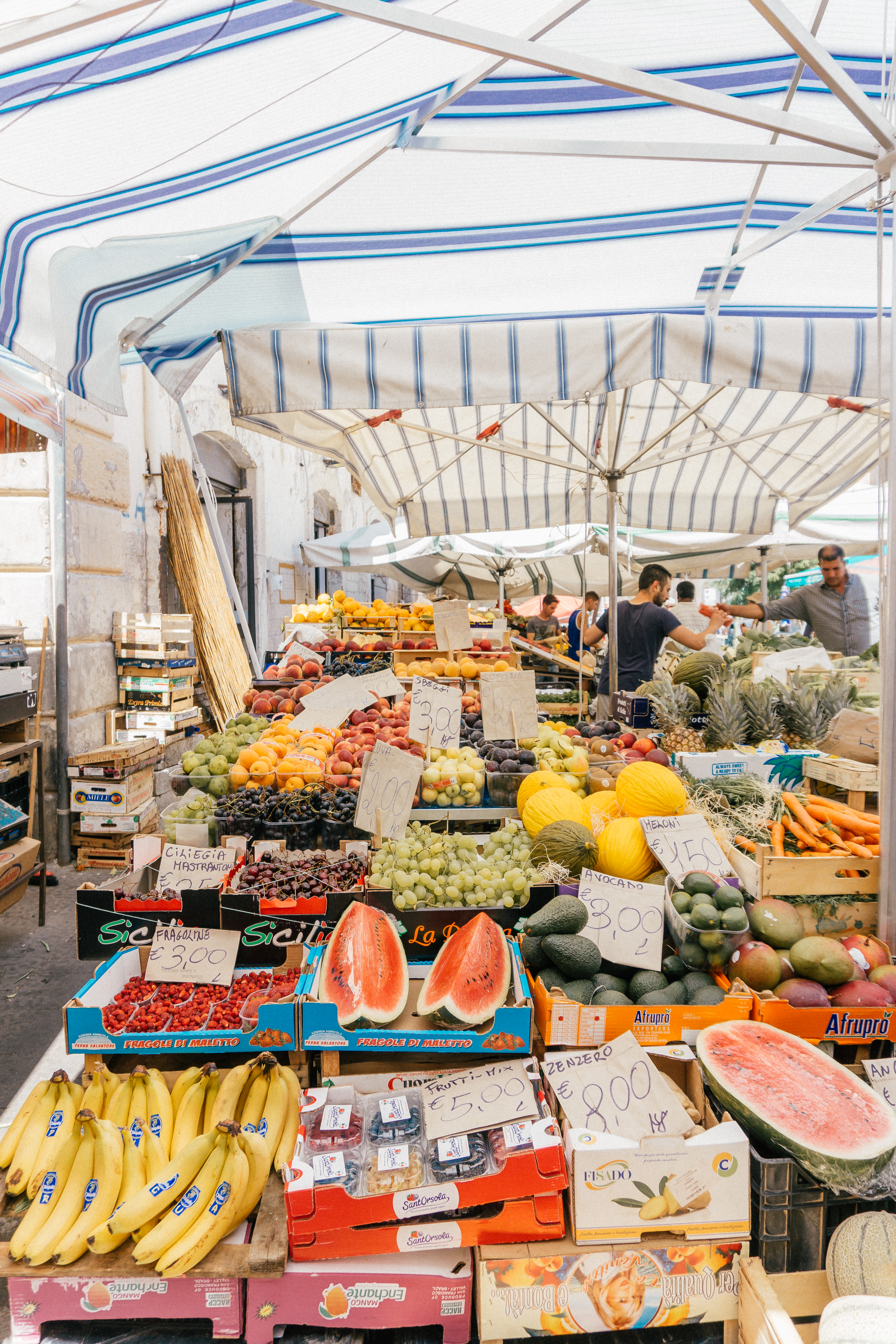 A colourful fresh fruit stall at the authentic open air market in Ortigia, Sicily.