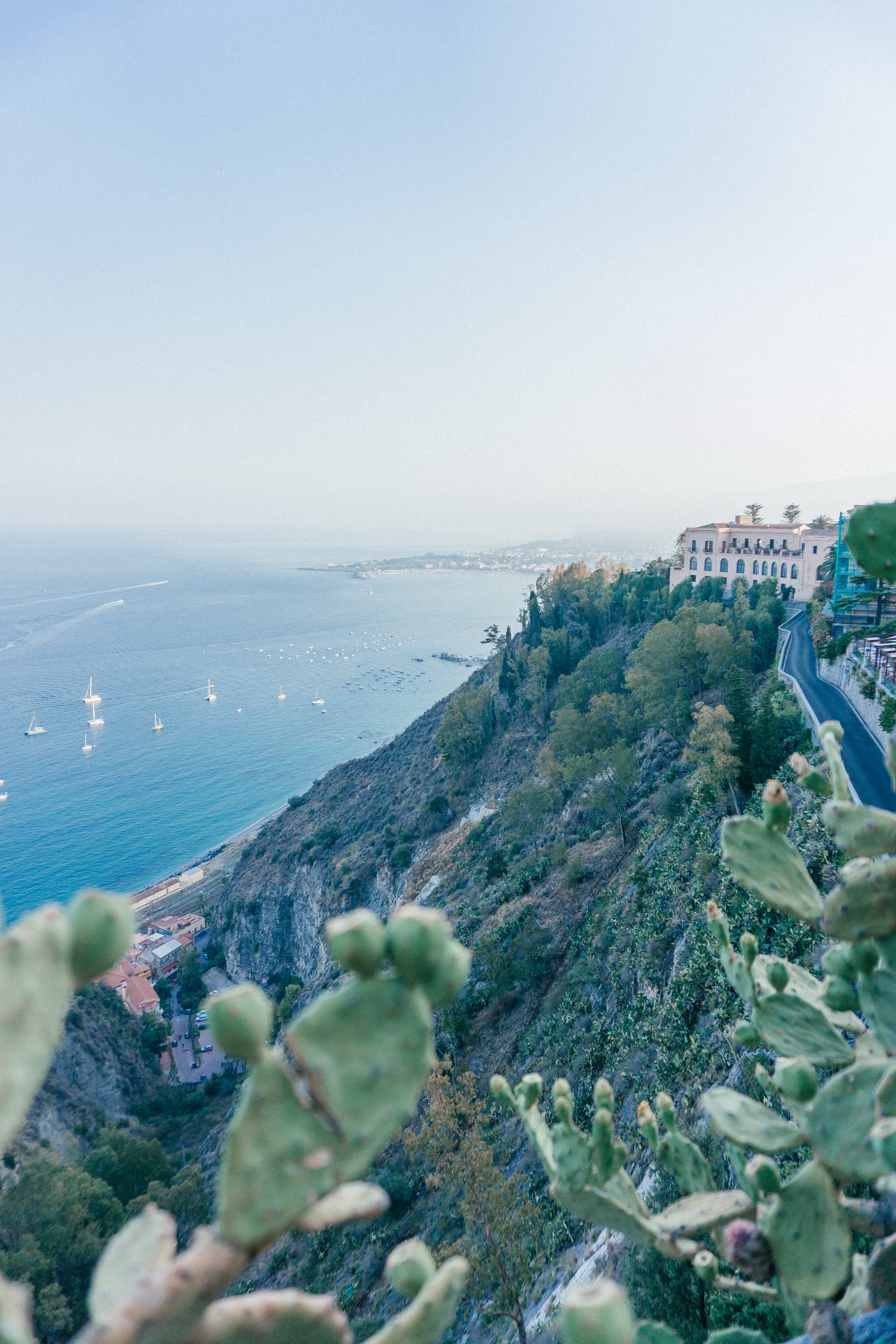 Looking down at the Mediterranean Sea views from the top of the cliff top town of Taormina in Sicily.