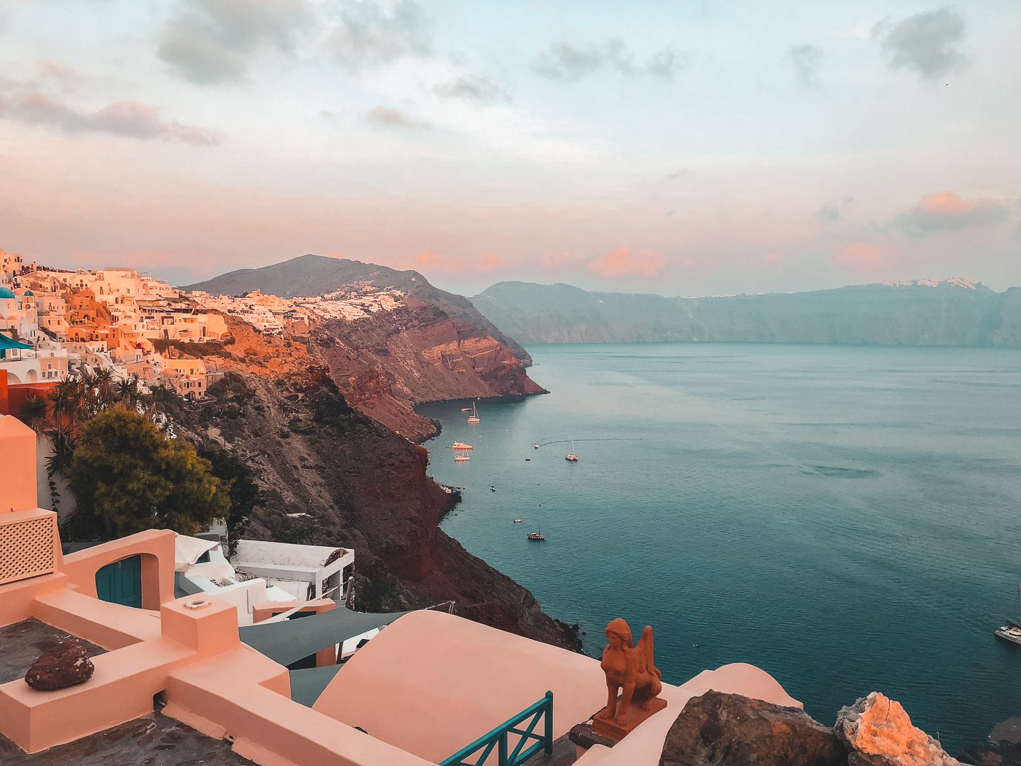 Golden hour on Santorini Island with Fira in the distance - a must see when  spending 10 days in Greece itinerary