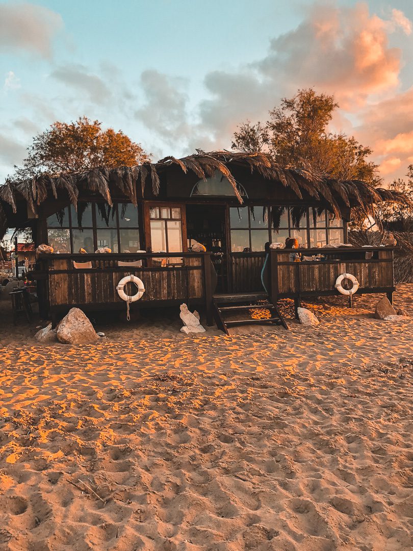 A cute beach bar near the village of Stavros glows at Golden hour.