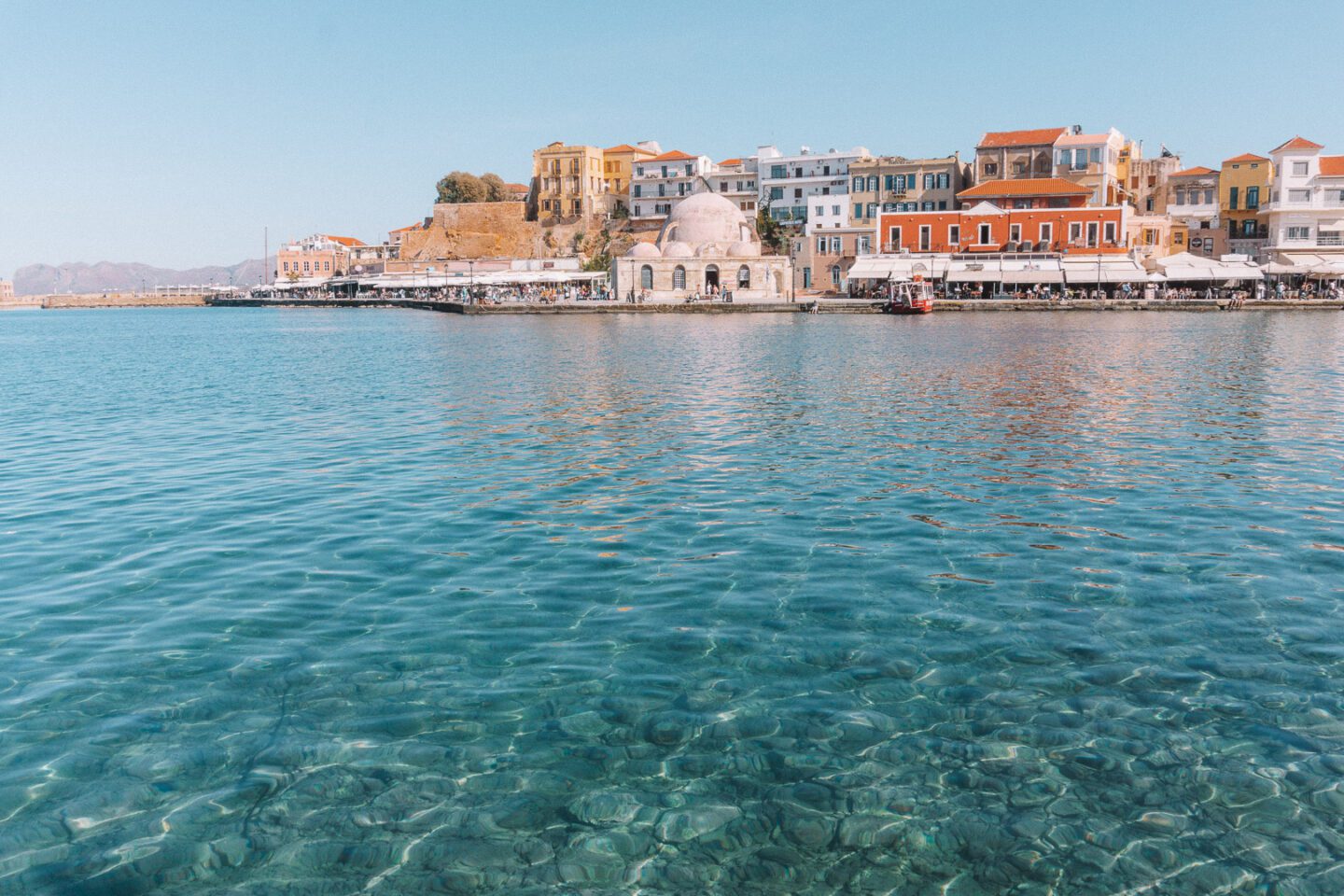 One of the top things to do in Crete Greece is see Chania's old town with it's colourful buildings along the waterfront