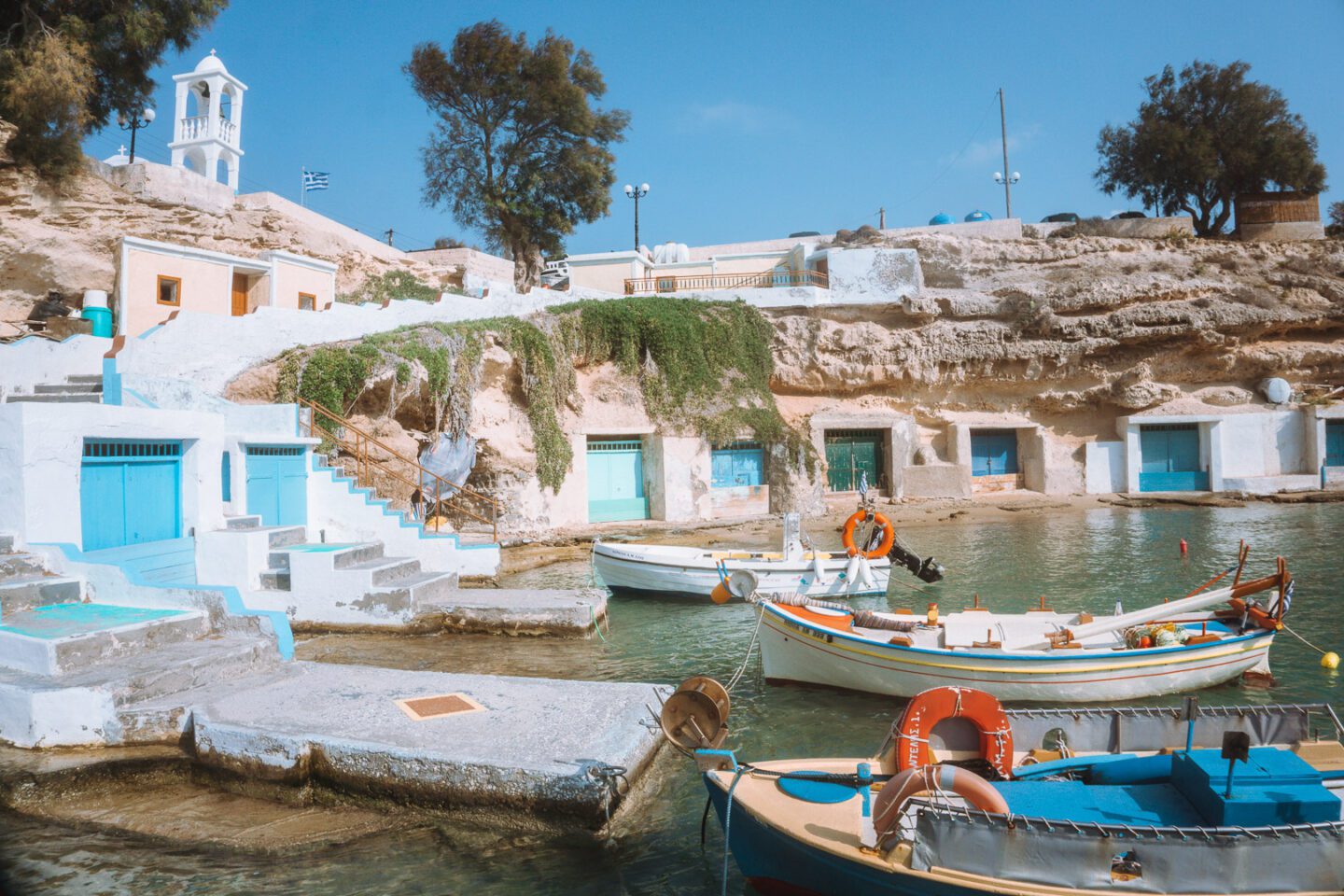 The colourful boat sheds and boats of Mandrakia, a charming fishing village on the island of Milos in Greece.