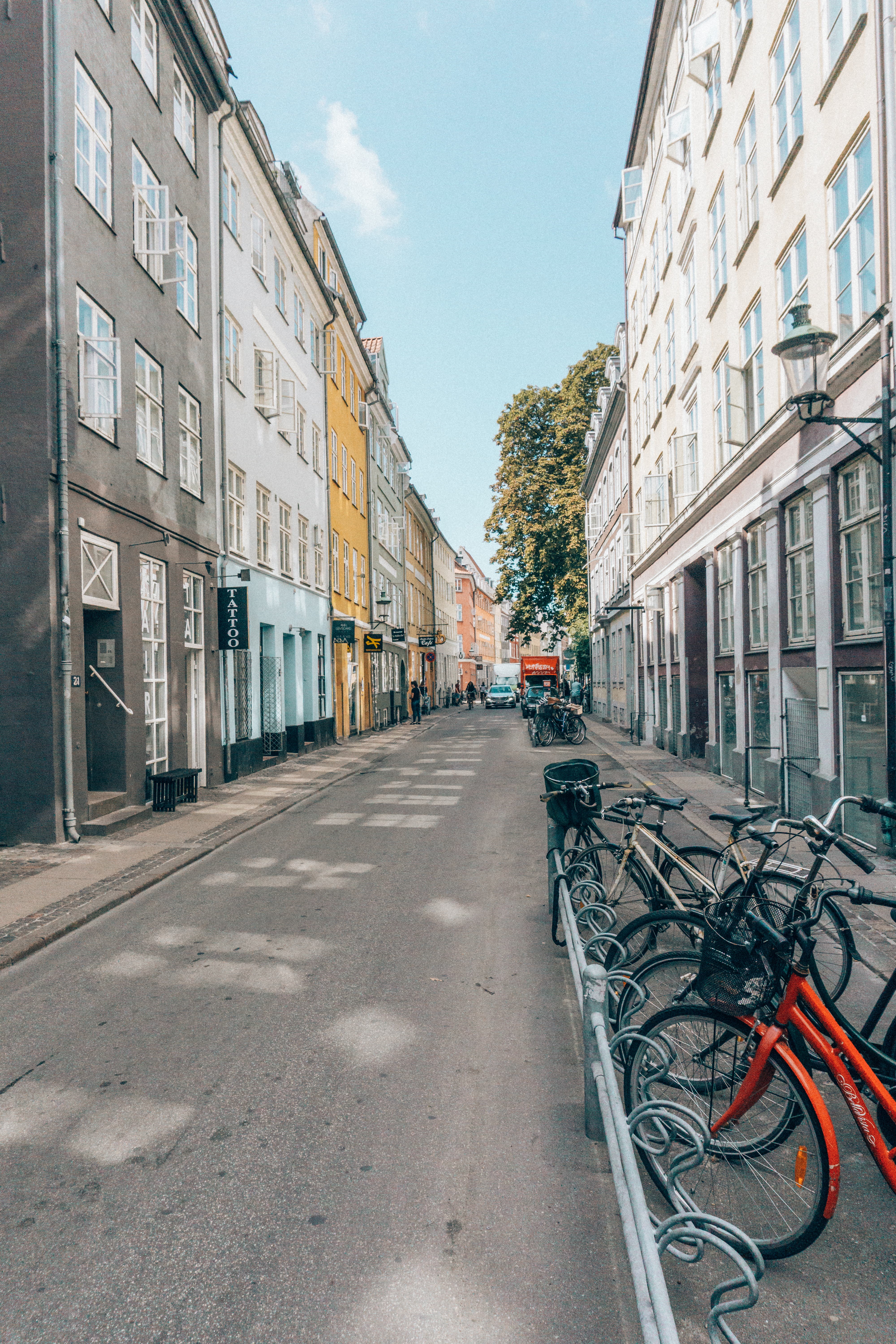 Bikes and colourful apartment buildings line a typical laneway in Copenhagen