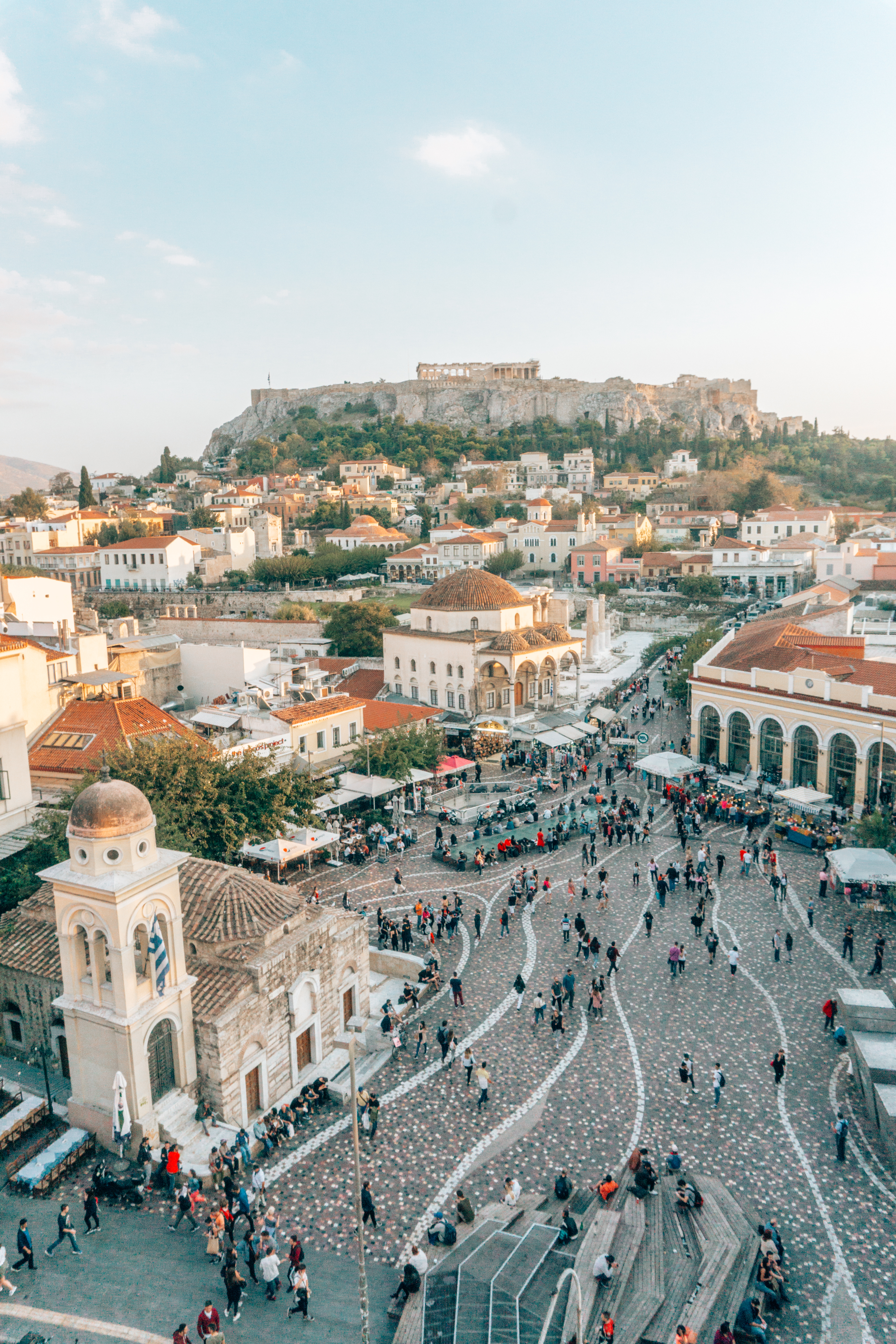 Looking down at tourists wandering the Plaka neighbourhood and the Acropolis towering over Athens on the top of the hill