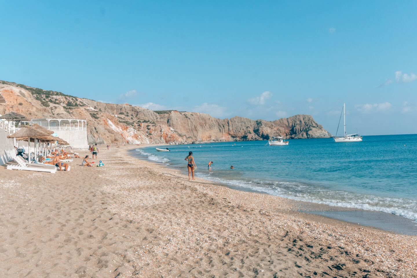 10 Days in Greece Itinerary - People relaxing, sailing and swimming at Paralia Paleochori beach on Milos Island in Greece. 