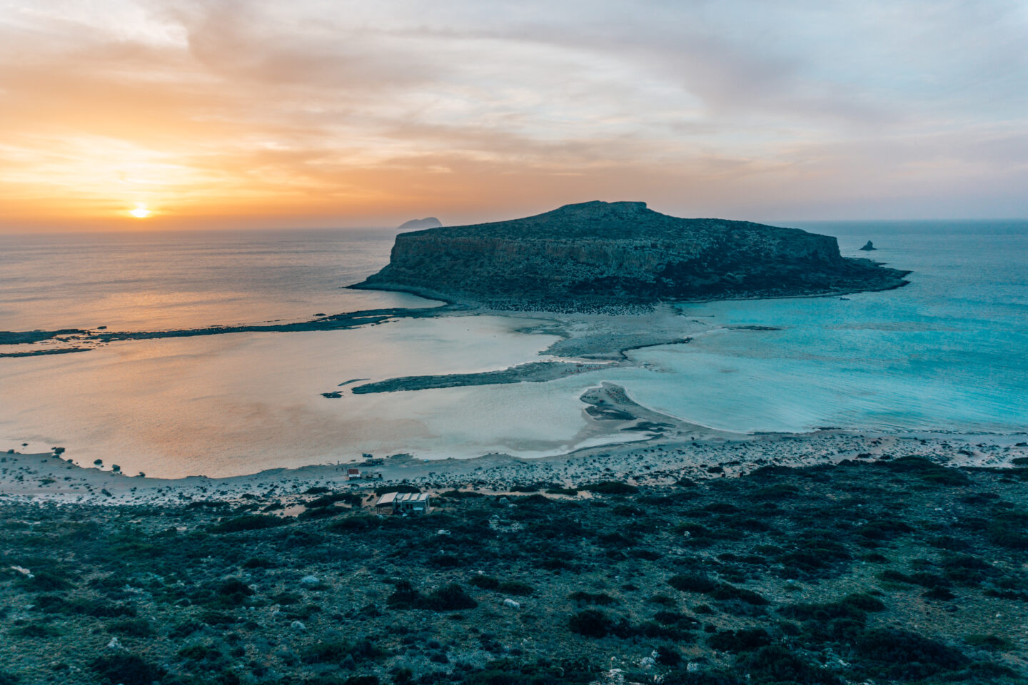 The sunsets over Balos Beach, in Crete, makes it's blue lagoon glow