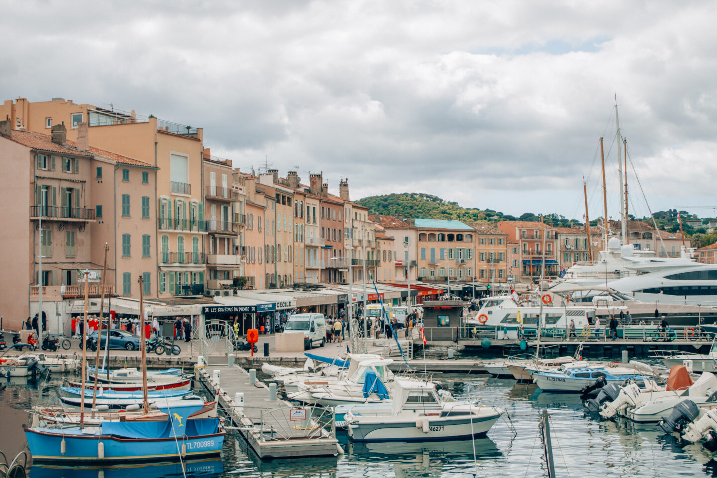 The seaside town and marina of Saint Tropez, France is fill with large yatchs, and colourful buildings in the summer months.