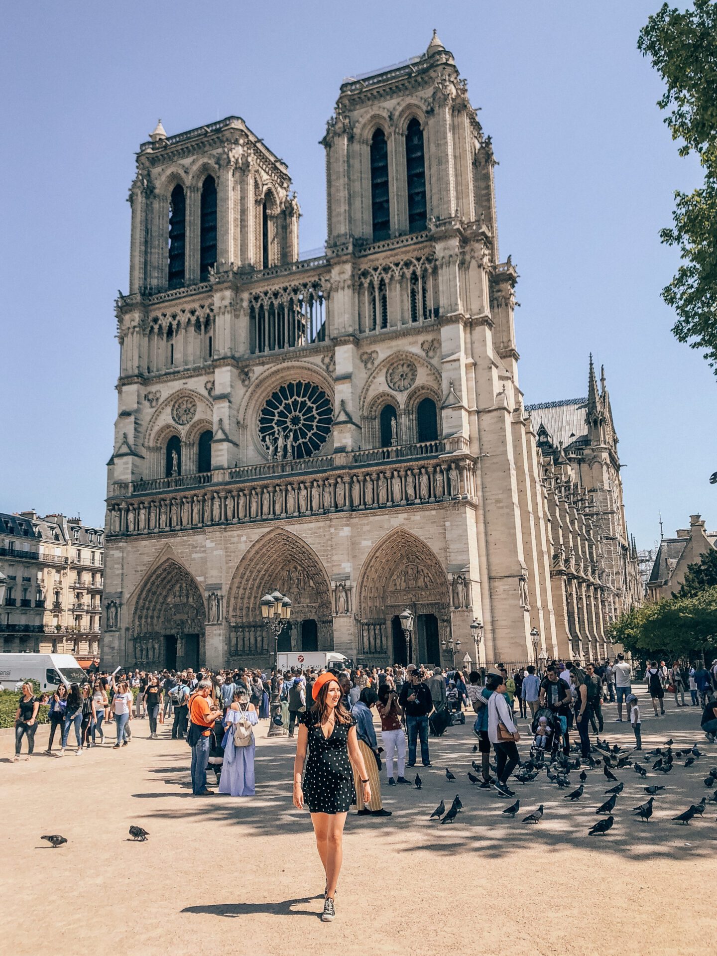 A girl walks in front of Notre Dame Cathedral in Paris, which is a top place to visit in France. 