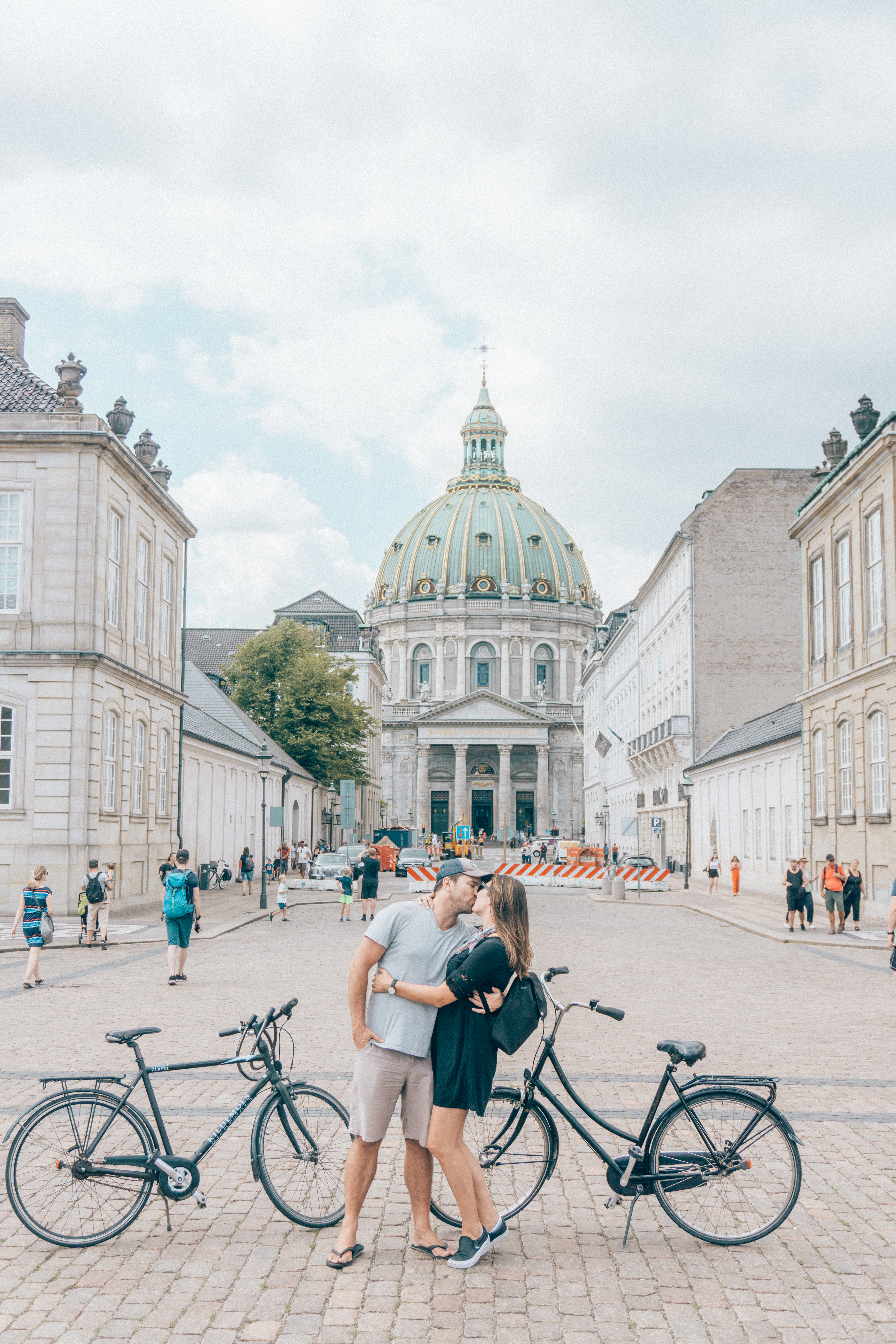 A couple kisses in front of their bikes while parked out front of the Frederik’s Church (or Marble Church) in Copenhagen