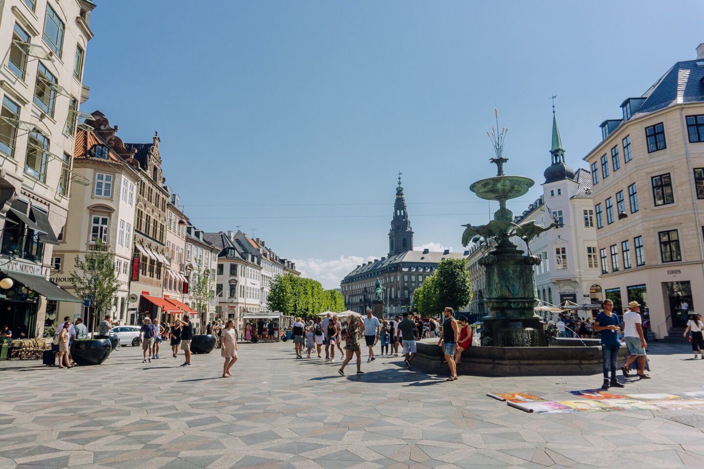 Blue skies on a summer's day and people walking on Strøget, Copenhagen's main shopping street and one of Europe's longest pedestrian streets