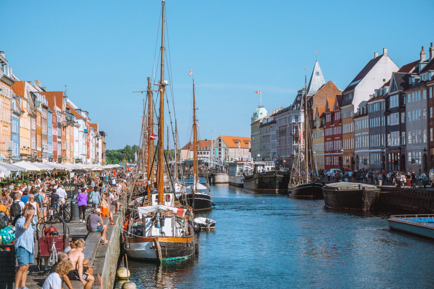 Nyhavn, the charming 17th-century waterfront district in Copenhagen that is a top thing to do for any tourist. The area is lined with colourful historic buildings, and numerous boats bobbing on the canal.