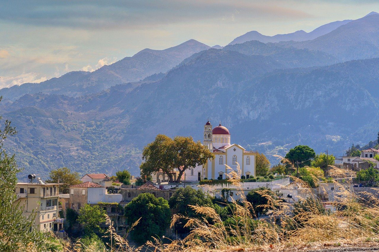  An old Monastery, Church with a red domed roof sits in in the mountain village of Lakki in the Lefka Ori on the road from Hania to Omalos on Crete Island. 