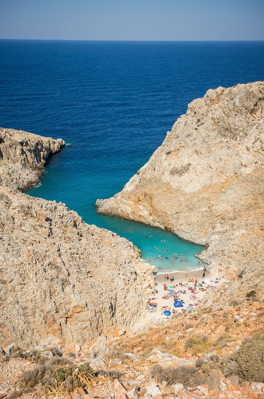 Tourists swim in the blue waters at the unique Seitan Limania Beach near Chania, Crete