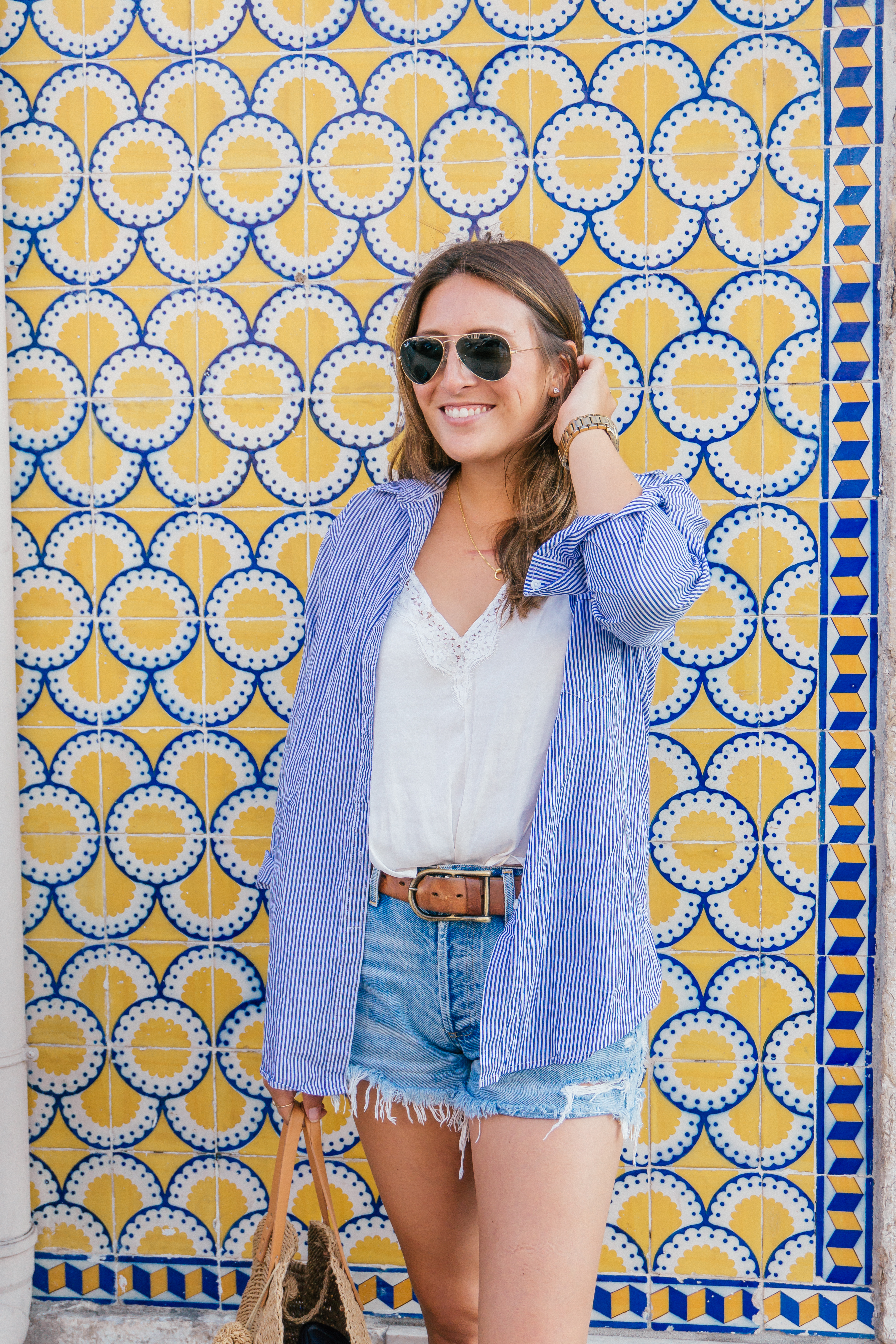 A trendy European summer outfit to wear in Lisbon Portugal so you match the yellow and blue tiles. 