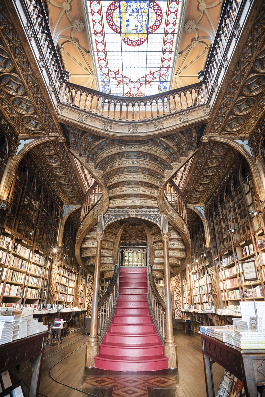 The enchanting interiors of the famous Livraria Lello bookshop in Porto, Portugal, with it's grand wooden staircase and stained glass window ceiling