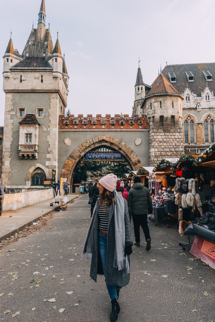 A girl walks away from the Vajdahunyad Castle Christmas Market in Budapest, Hungary