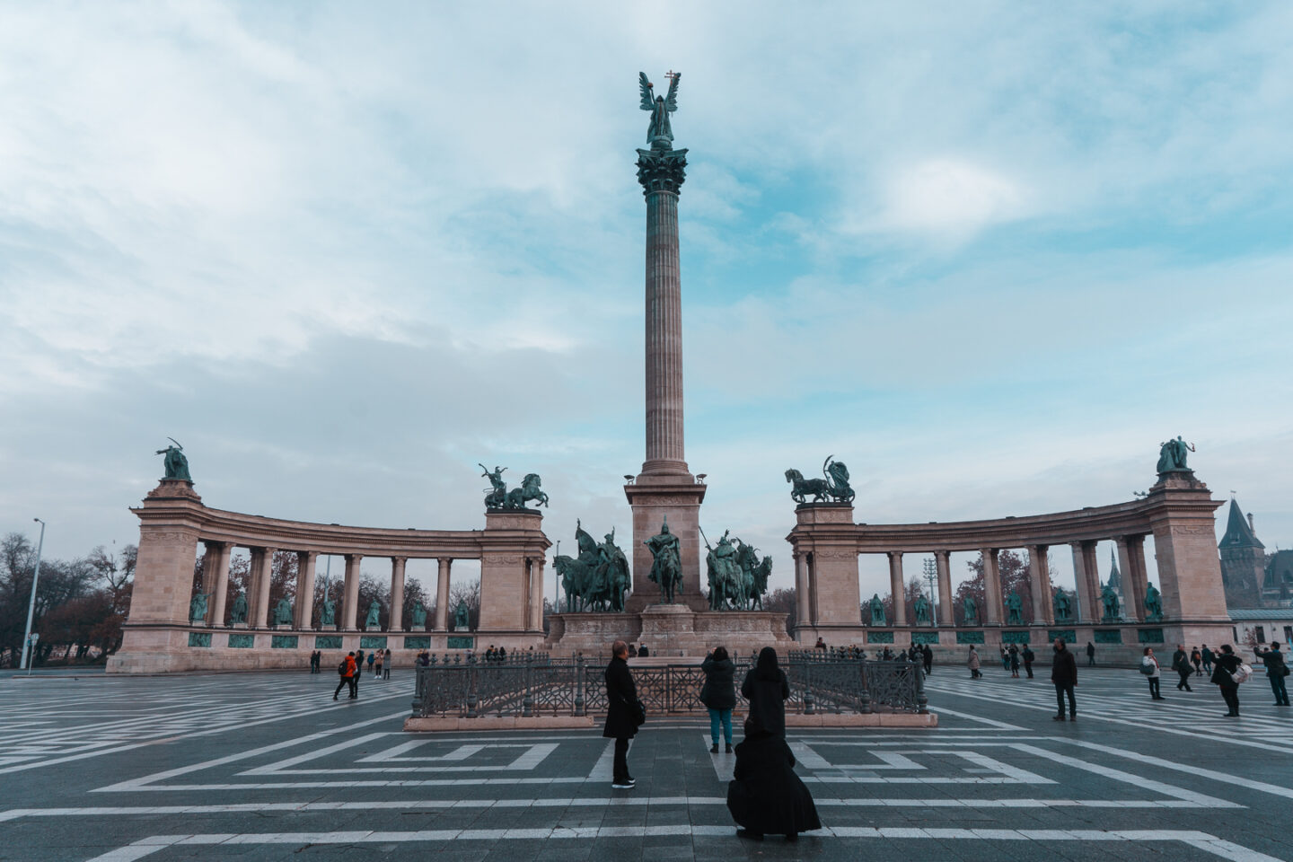 Tourists admiring Hero's square - a must-do on your 3 day Budapest itinerary.