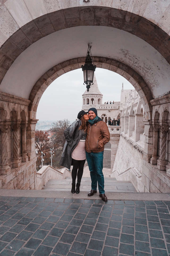 A couple kisses under the arches of Fisherman's Bastion, in Budapest, Hungary