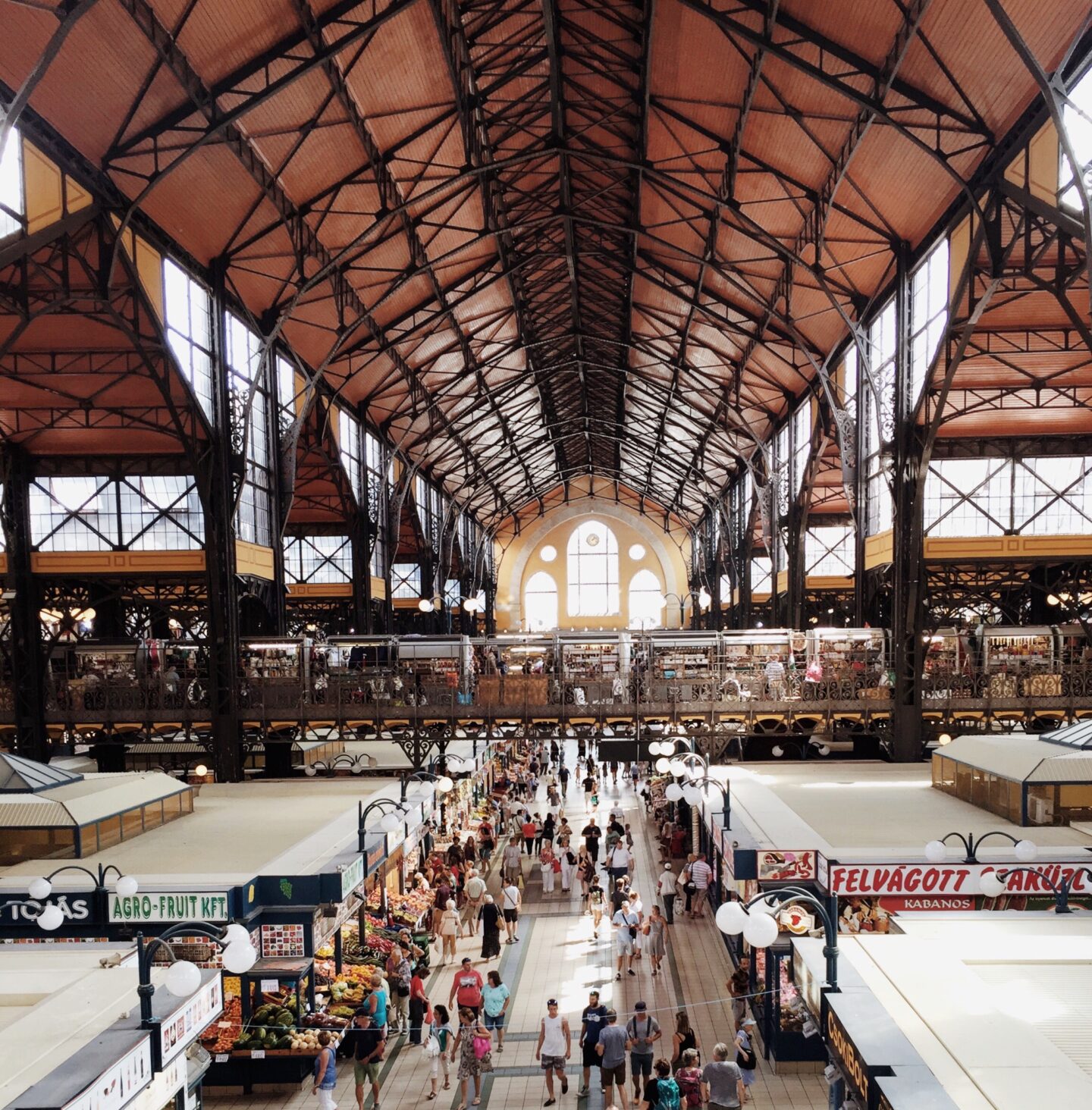 Looking over Central Market Hall with people walking between the stalls in Budapest