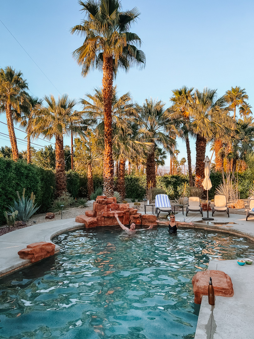 A private pool in at our Palm Spring VRBO with palm trees surrounding the backyard