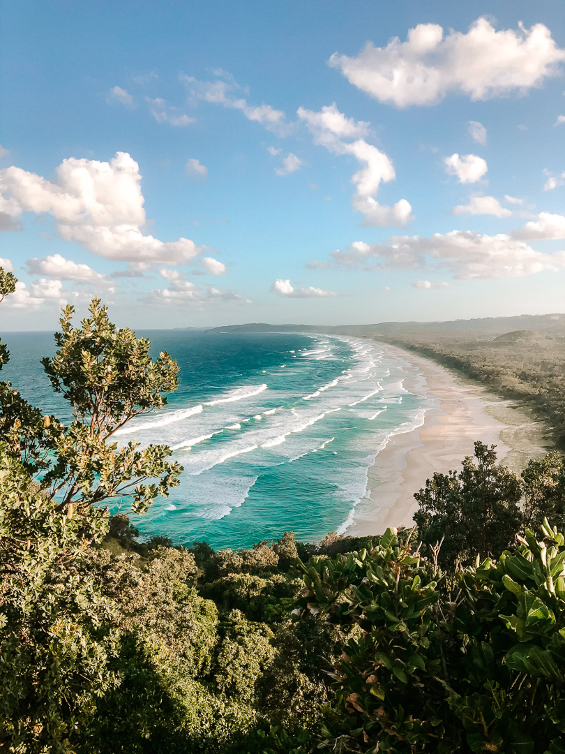 Looking down at the waves and long sandy beach of Tallows beach in Byron Bay.
